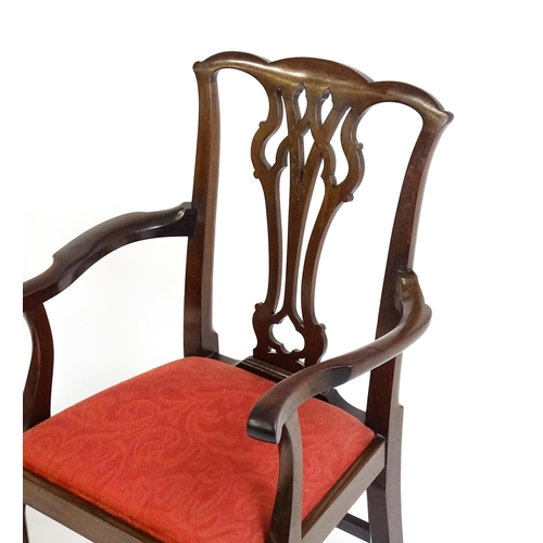 1567 - A pair of Chippendale style mahogany elbow chairs with a drop in seat raised on chamfered legs unite... 