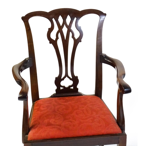 1567 - A pair of Chippendale style mahogany elbow chairs with a drop in seat raised on chamfered legs unite... 