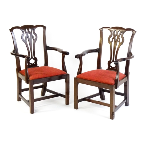 1567 - A pair of Chippendale style mahogany elbow chairs with a drop in seat raised on chamfered legs unite... 