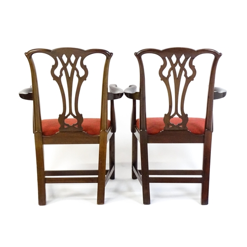 1567 - A pair of Chippendale style mahogany elbow chairs with a drop in seat raised on chamfered legs unite... 