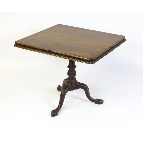 1568 - A mid / late 18thC mahogany tilt top table with an unusual moulded surround, re-entrant corners and ... 