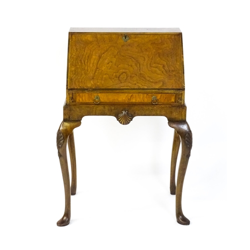 1572 - An Edwardian Queen Anne style walnut bureau on stand, the fall front opening to show pigeon holes,  ... 