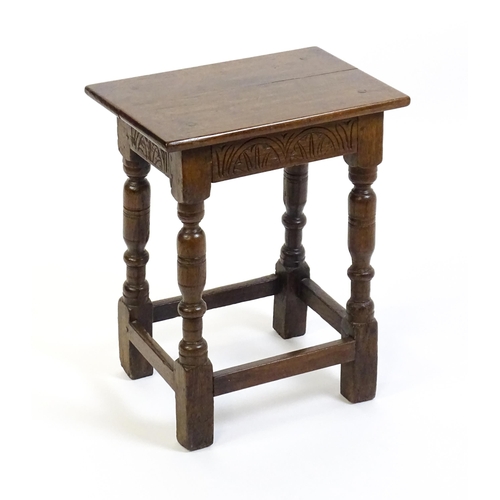 1574 - A 19thC peg jointed oak stool with a rectangular top above four turned tapering legs united by a box... 