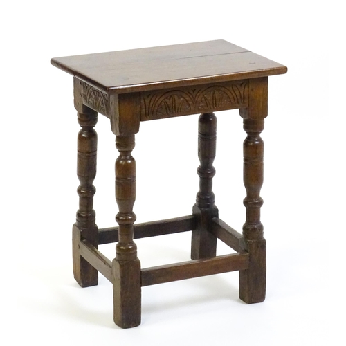 1574 - A 19thC peg jointed oak stool with a rectangular top above four turned tapering legs united by a box... 