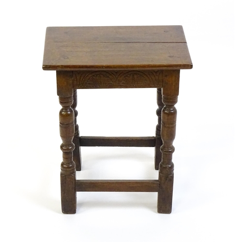 1574 - A 19thC peg jointed oak stool with a rectangular top above four turned tapering legs united by a box... 