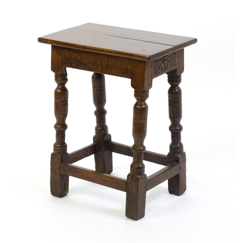 1574 - A 19thC peg jointed oak stool with a rectangular top above four turned tapering legs united by a box... 