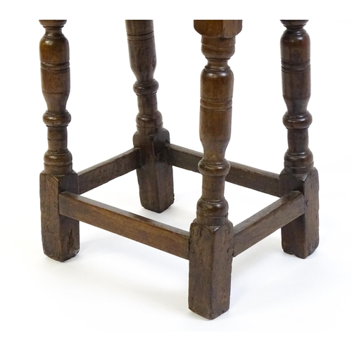 1574 - A 19thC peg jointed oak stool with a rectangular top above four turned tapering legs united by a box... 