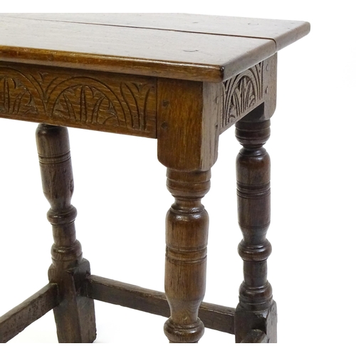 1574 - A 19thC peg jointed oak stool with a rectangular top above four turned tapering legs united by a box... 