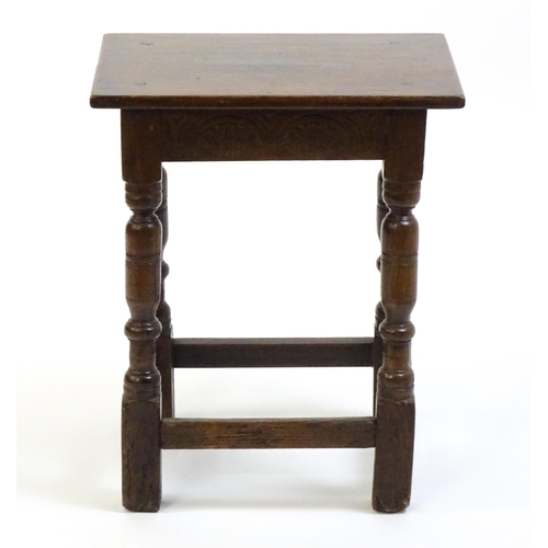 1574 - A 19thC peg jointed oak stool with a rectangular top above four turned tapering legs united by a box... 