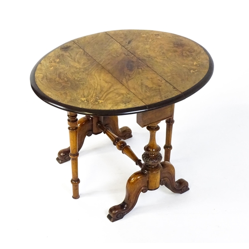 1580 - A late 19thC walnut veneered Sutherland table with two demi lune drop leaves raised on two turned an... 