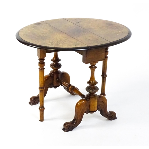 1580 - A late 19thC walnut veneered Sutherland table with two demi lune drop leaves raised on two turned an... 