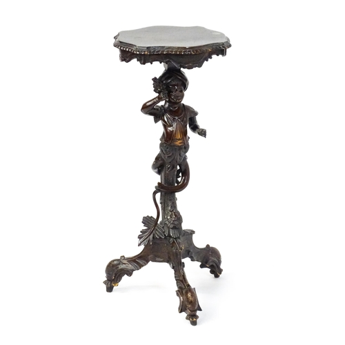 1581 - A 19thC side table with a shaped top above a carved caryatid style figural pedestal grasping a bunch... 