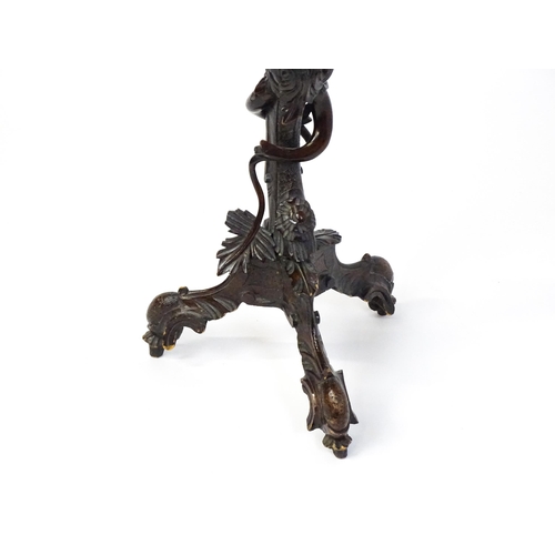 1581 - A 19thC side table with a shaped top above a carved caryatid style figural pedestal grasping a bunch... 