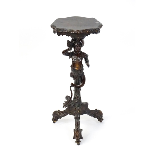 1581 - A 19thC side table with a shaped top above a carved caryatid style figural pedestal grasping a bunch... 