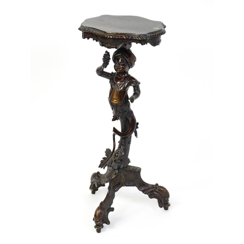 1581 - A 19thC side table with a shaped top above a carved caryatid style figural pedestal grasping a bunch... 