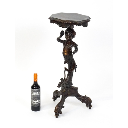 1581 - A 19thC side table with a shaped top above a carved caryatid style figural pedestal grasping a bunch... 