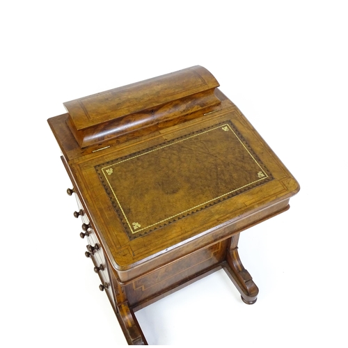 1587 - A mid / late 19thC walnut Davenport surmounted by a hinged writing compartment. The writing slope ha... 