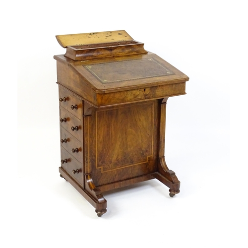 1587 - A mid / late 19thC walnut Davenport surmounted by a hinged writing compartment. The writing slope ha... 