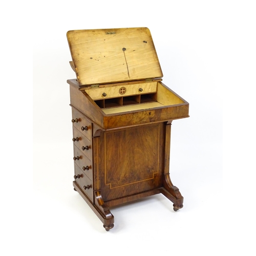 1587 - A mid / late 19thC walnut Davenport surmounted by a hinged writing compartment. The writing slope ha... 