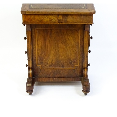 1587 - A mid / late 19thC walnut Davenport surmounted by a hinged writing compartment. The writing slope ha... 