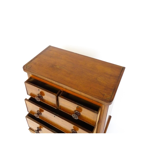 1589 - A Victorian mahogany chest of drawers with a veneered oblong top above two short over two drawers wi... 