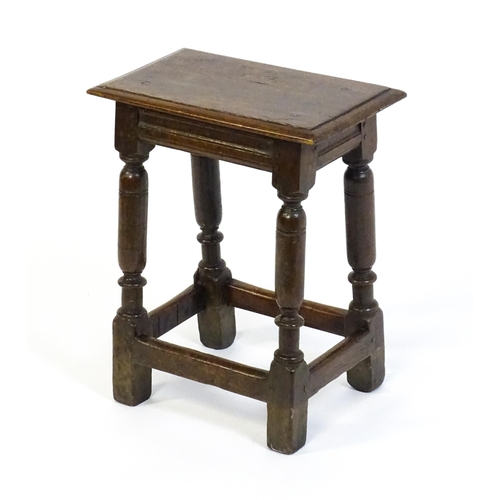 1590 - A 17thC oak joint stool with a moulded top above four turned tapering legs united by a box stretcher... 