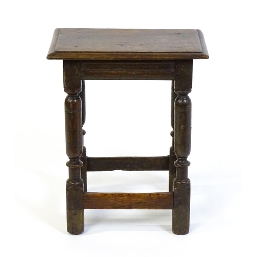 1590 - A 17thC oak joint stool with a moulded top above four turned tapering legs united by a box stretcher... 