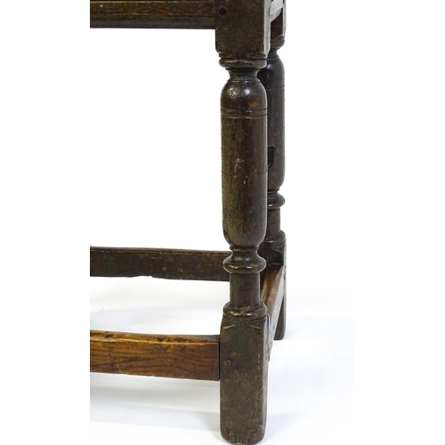 1590 - A 17thC oak joint stool with a moulded top above four turned tapering legs united by a box stretcher... 