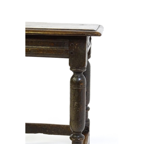 1590 - A 17thC oak joint stool with a moulded top above four turned tapering legs united by a box stretcher... 