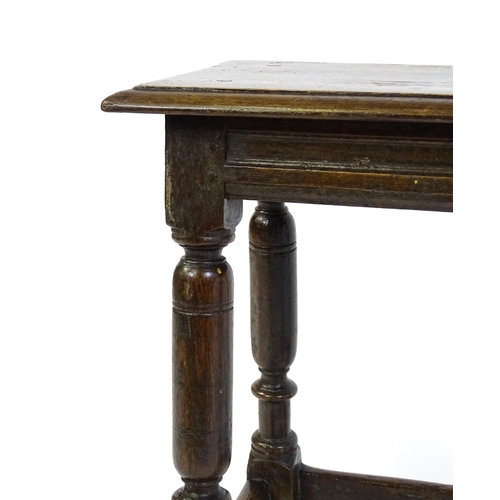 1590 - A 17thC oak joint stool with a moulded top above four turned tapering legs united by a box stretcher... 