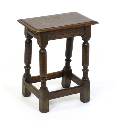 1590 - A 17thC oak joint stool with a moulded top above four turned tapering legs united by a box stretcher... 