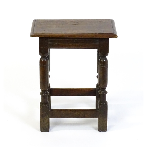 1590 - A 17thC oak joint stool with a moulded top above four turned tapering legs united by a box stretcher... 