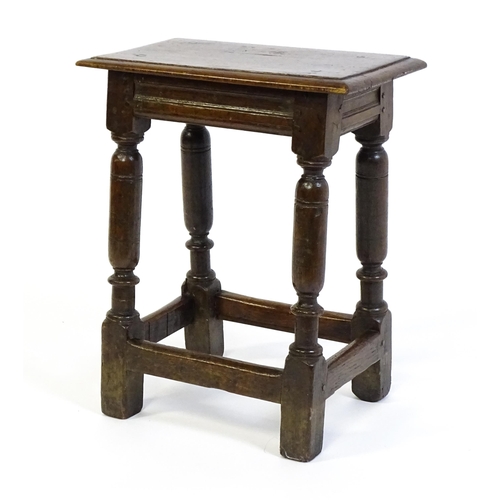 1590 - A 17thC oak joint stool with a moulded top above four turned tapering legs united by a box stretcher... 