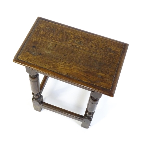 1590 - A 17thC oak joint stool with a moulded top above four turned tapering legs united by a box stretcher... 