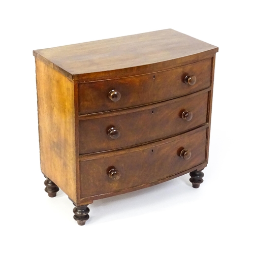 1594 - A late 18thC / early 19thC mahogany bow fronted chest of drawers comprising three long drawers raise... 