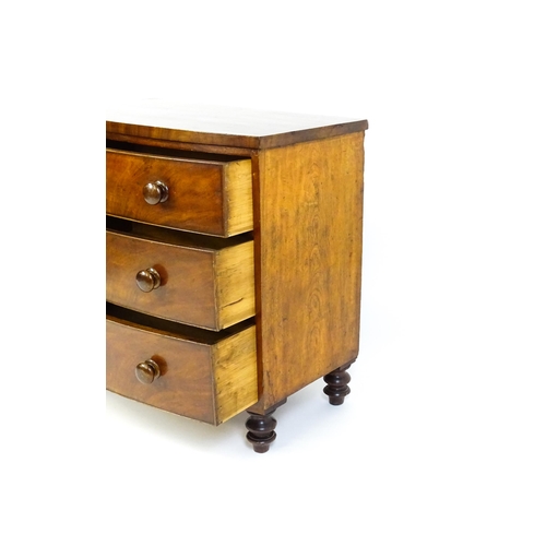 1594 - A late 18thC / early 19thC mahogany bow fronted chest of drawers comprising three long drawers raise... 