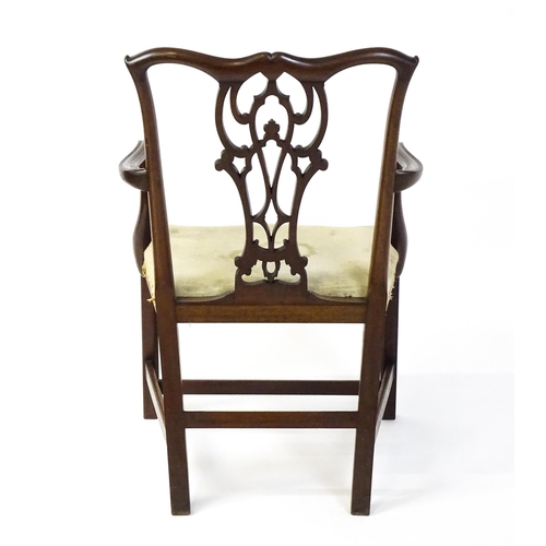 1596 - An early 20thC mahogany Chippendale elbow chair with a shaped top rail, a pierced and carved vase sh... 