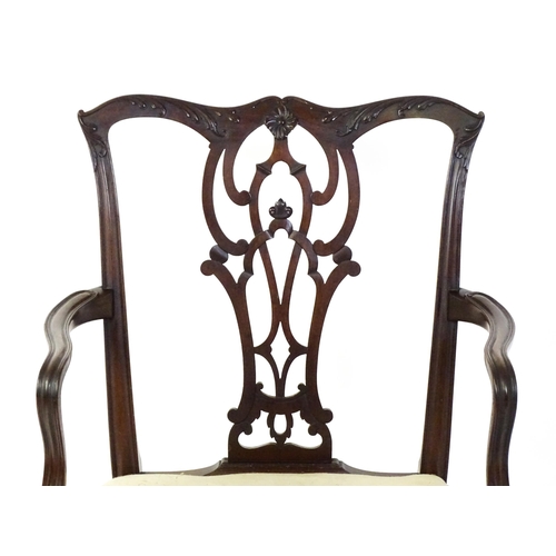 1596 - An early 20thC mahogany Chippendale elbow chair with a shaped top rail, a pierced and carved vase sh... 