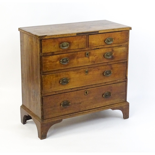 1602 - A late Georgian fruitwood chest of drawers comprising two short over three long drawers raised on sh... 