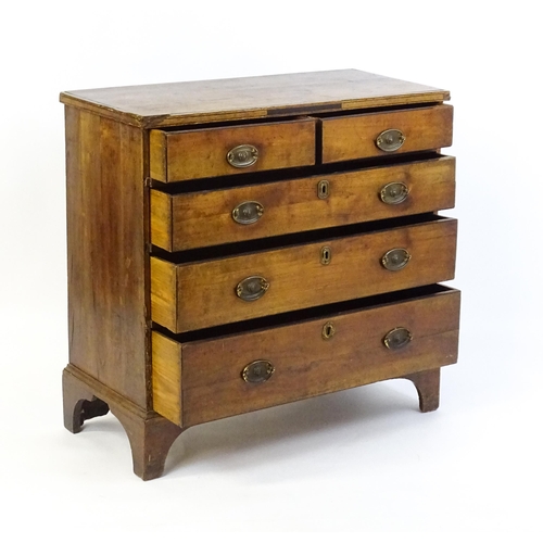 1602 - A late Georgian fruitwood chest of drawers comprising two short over three long drawers raised on sh... 