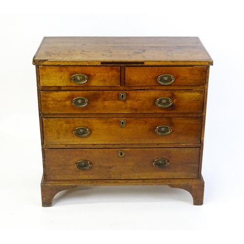 1602 - A late Georgian fruitwood chest of drawers comprising two short over three long drawers raised on sh... 