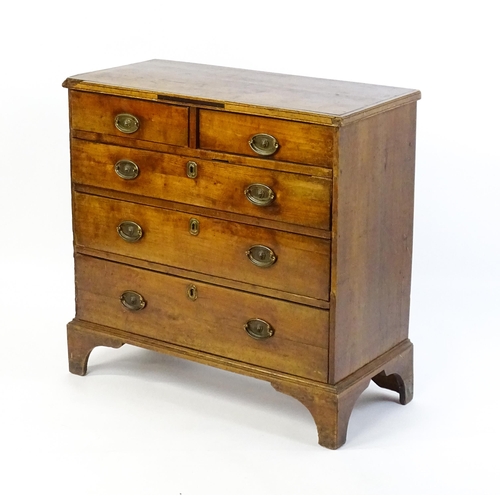 1602 - A late Georgian fruitwood chest of drawers comprising two short over three long drawers raised on sh... 