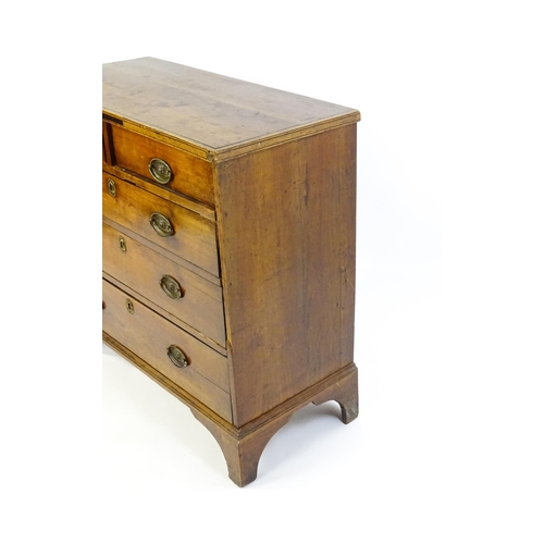 1602 - A late Georgian fruitwood chest of drawers comprising two short over three long drawers raised on sh... 