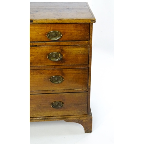 1602 - A late Georgian fruitwood chest of drawers comprising two short over three long drawers raised on sh... 