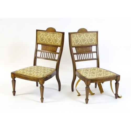 1603 - A pair of Edwardian walnut side chairs with satinwood marquetry decoration raised on tapering legs t... 