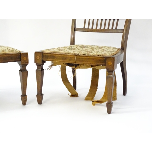 1603 - A pair of Edwardian walnut side chairs with satinwood marquetry decoration raised on tapering legs t... 