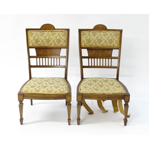 1603 - A pair of Edwardian walnut side chairs with satinwood marquetry decoration raised on tapering legs t... 