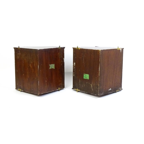 1604 - A pair of mid 20thC walnut corner cabinets. Bearing labels to back panels. 21 1/2 high x 26