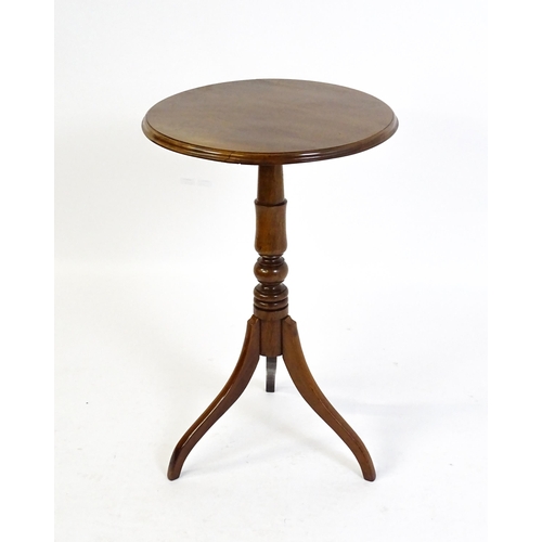 1609 - A mahogany tripod occasional table with a circular moulded top above a turned pedestal and raised on... 