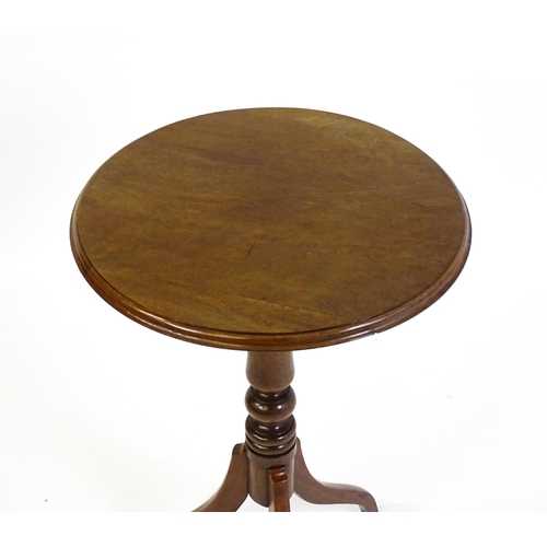 1609 - A mahogany tripod occasional table with a circular moulded top above a turned pedestal and raised on... 